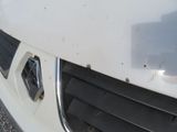 a close up of a car ' s front grill with a hole in it