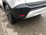 a close up of the rear end of a silver car