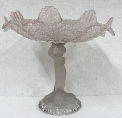 an image of a glass bowl with a woman holding a fish