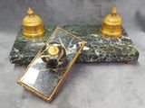 a marble table topped with a mirror and a golden clock