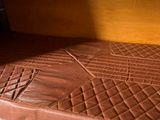 a bed in the back of a van with a brown mattress