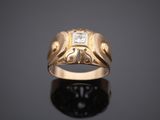 a gold ring with a diamond set in the center