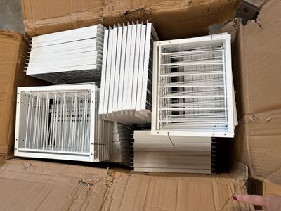 many air conditioners in a cardboard box on the floor
