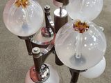 a glass table with a bunch of glass lamps on it