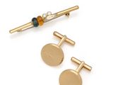 two pairs of gold tone cufflinks and a beaded tie bar