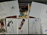 a lot of drawings and pictures on the table