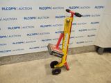 a yellow and red hand truck with a red handle