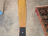 a yellow umbrella laying on the floor next to a rug