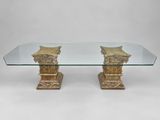 a glass table with two columns and a glass top
