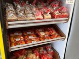 many bags of food on the shelves in the store