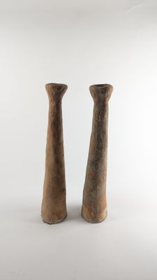 two vases that are sitting on a white surface
