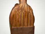 an image of a wooden sculpture of a man with long hair
