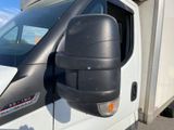 a white truck with a black side view mirror on it