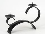a black candle holder that has two candles on it