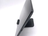 a close up of a laptop on a stand on a white surface