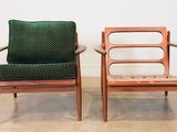 pair of mid century danish teak lounge chairs with green upholstered cushions