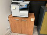a printer that is sitting on top of a cabinet