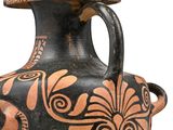 a black and orange vase with a design on it