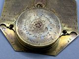 a gold plate with a clock on it on a blue surface