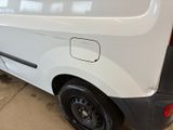 a white van parked in a garage with its door open