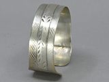 silver cuff bracelet with engraved design on the inside