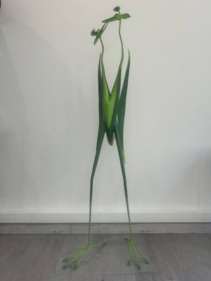 a sculpture of a frog that is standing on its hind legs