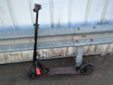 un scooter posé sur le sol à côté d'un mur