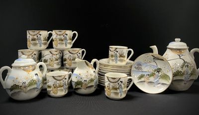 many cups and saucers and teapots on the table