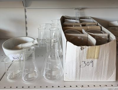 a box of empty glassware sitting on a shelf