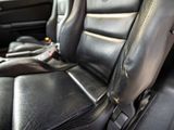 a close up of a car seat with a remote control in it