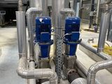 pipes and valves are lined up in a large industrial building
