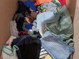 a cardboard box full of clothes and clothes that are in it