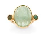 a close up of a ring with a green stone surrounded by green stones