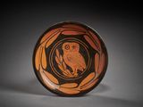 un bol orange et noir orné d'un hibou
