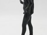 statue of a man standing on a pedestal with a cell phone in his hand