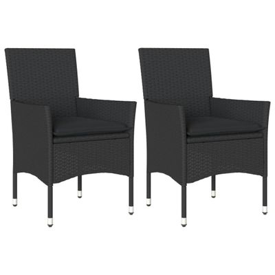 a pair of black wicker dining chairs with black cushions