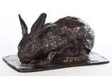une image représentant une statue de lapin assis sur une assiette