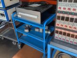 a blue cart with a bunch of electronic equipment on it