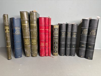 several old books are lined up on a shelf next to each other
