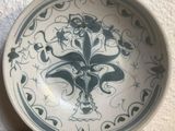 a blue and white plate with a design on it