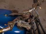 a close up of a motorcycle with a blue tank