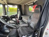 the interior of a van with a black seat and steering wheel