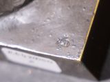 a close up of a metal object with a tag on it