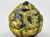 a gold and black ball with a dragon on it