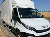 the white van is parked on the side of the road