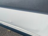 the side of a car with a denting dent on the side of it