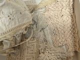 a white box filled with a lot of old laces