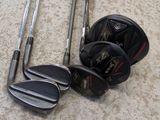 a lot of golf clubs that are laying on the floor