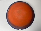 an orange bowl with a blue rim on a table