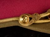 an image of a military hat with a gold medal on it